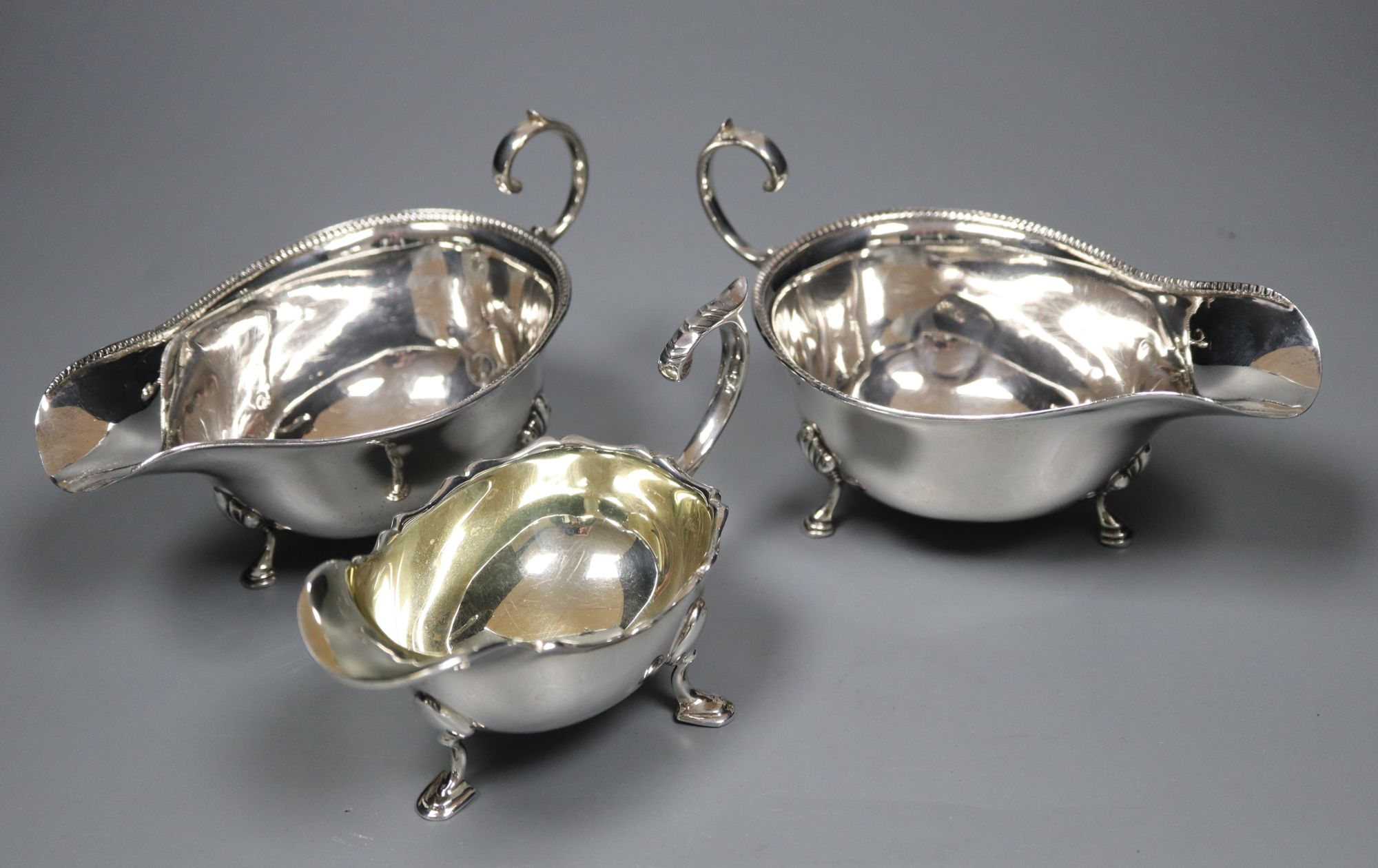 A pair of 1930s silver sauceboats, 5.5 oz and a plated sauceboat.